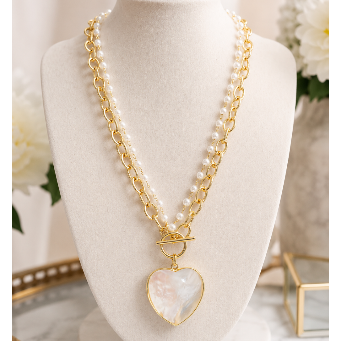 Pearl heart toggle necklace with gold chain and pearl accents.