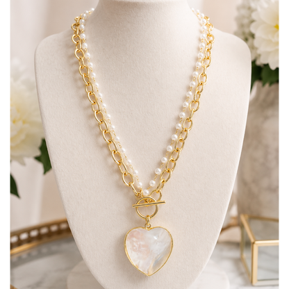Pearl heart toggle necklace with gold chain and pearl accents.